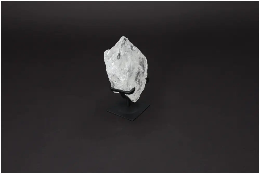 Rough Lemurian Quartz on metal stand, offering energy purification and harmonization, by Sylvia Crystals.