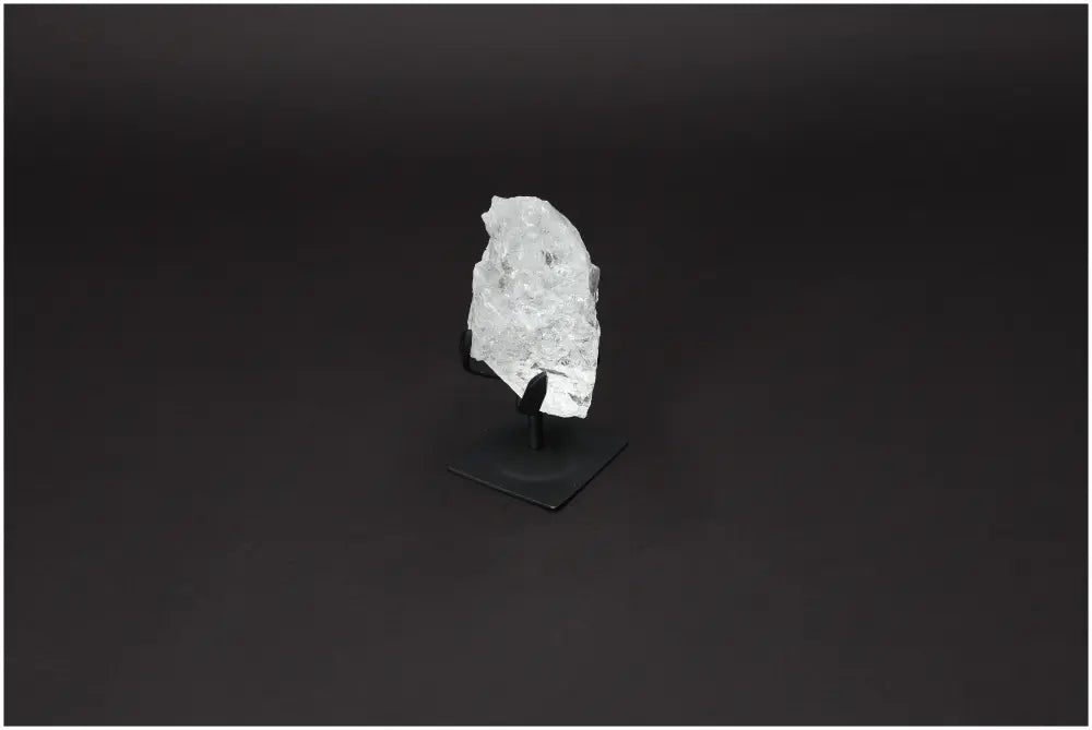 Rough Lemurian Quartz on elegant metal stand by Sylvia Crystals, symbolizing purity and mindfulness in sophisticated decor.