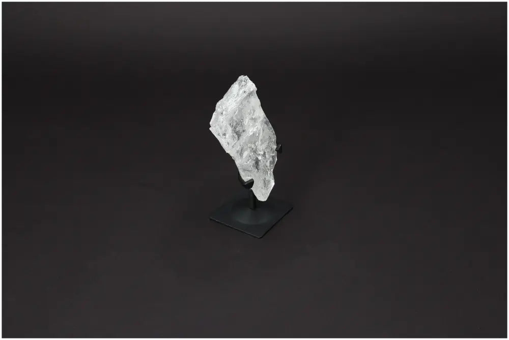 Rough Lemurian Quartz on metal stand showcasing its natural elegance and purification properties by Sylvia Crystals.