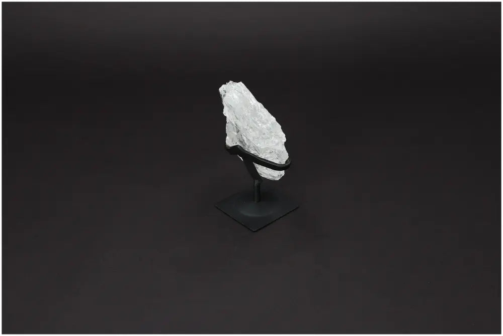 Rough Lemurian Quartz on metal stand, showcasing natural elegance and purification properties for body and mind harmonization.