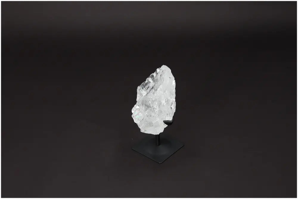 Rough Lemurian Quartz displayed on elegant metal stand, offering powerful energy harmonization and aesthetic appeal.