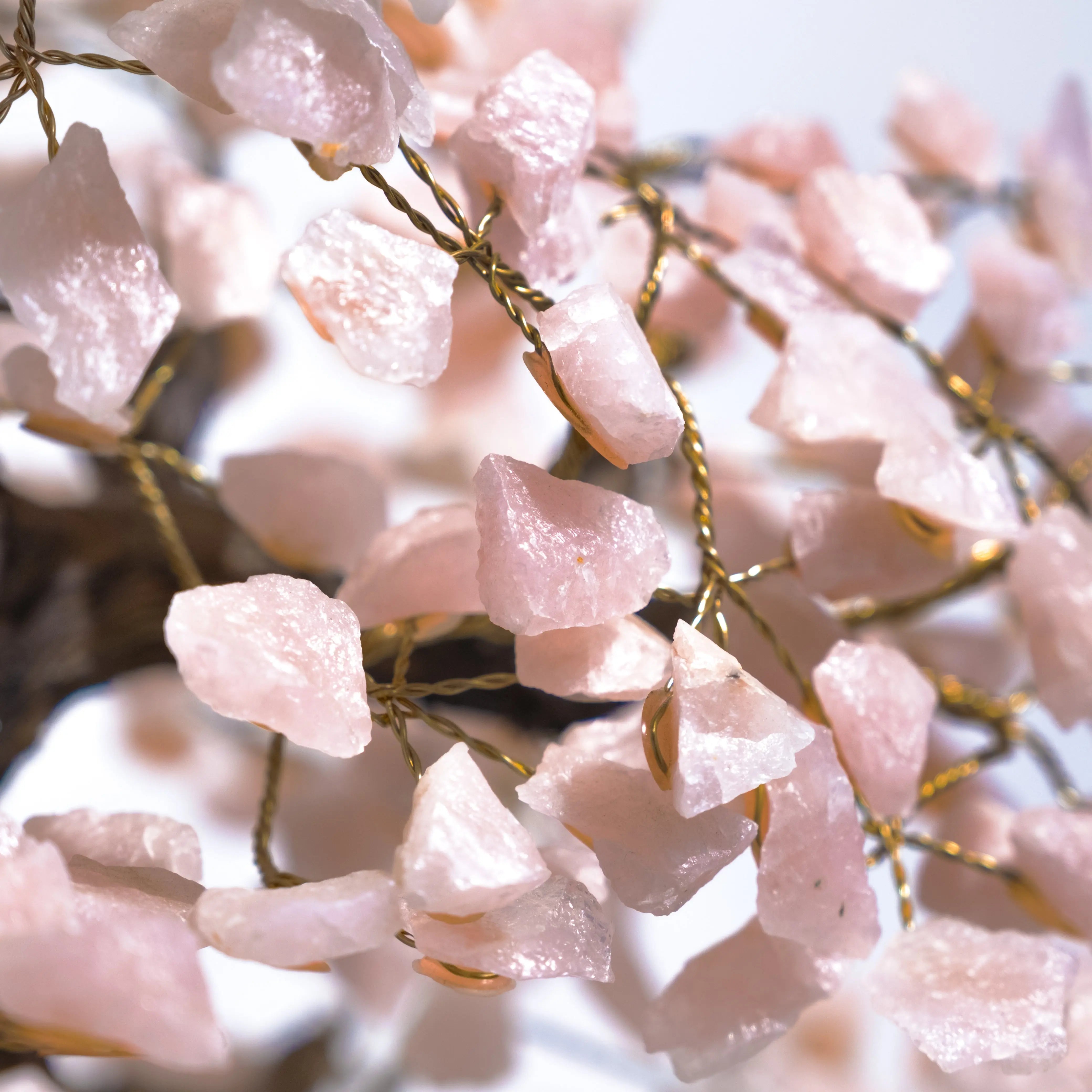 Close-up of a Rough Quartz Tree, featuring raw quartz crystals on golden wire branches, enhancing beauty and energy in any space.