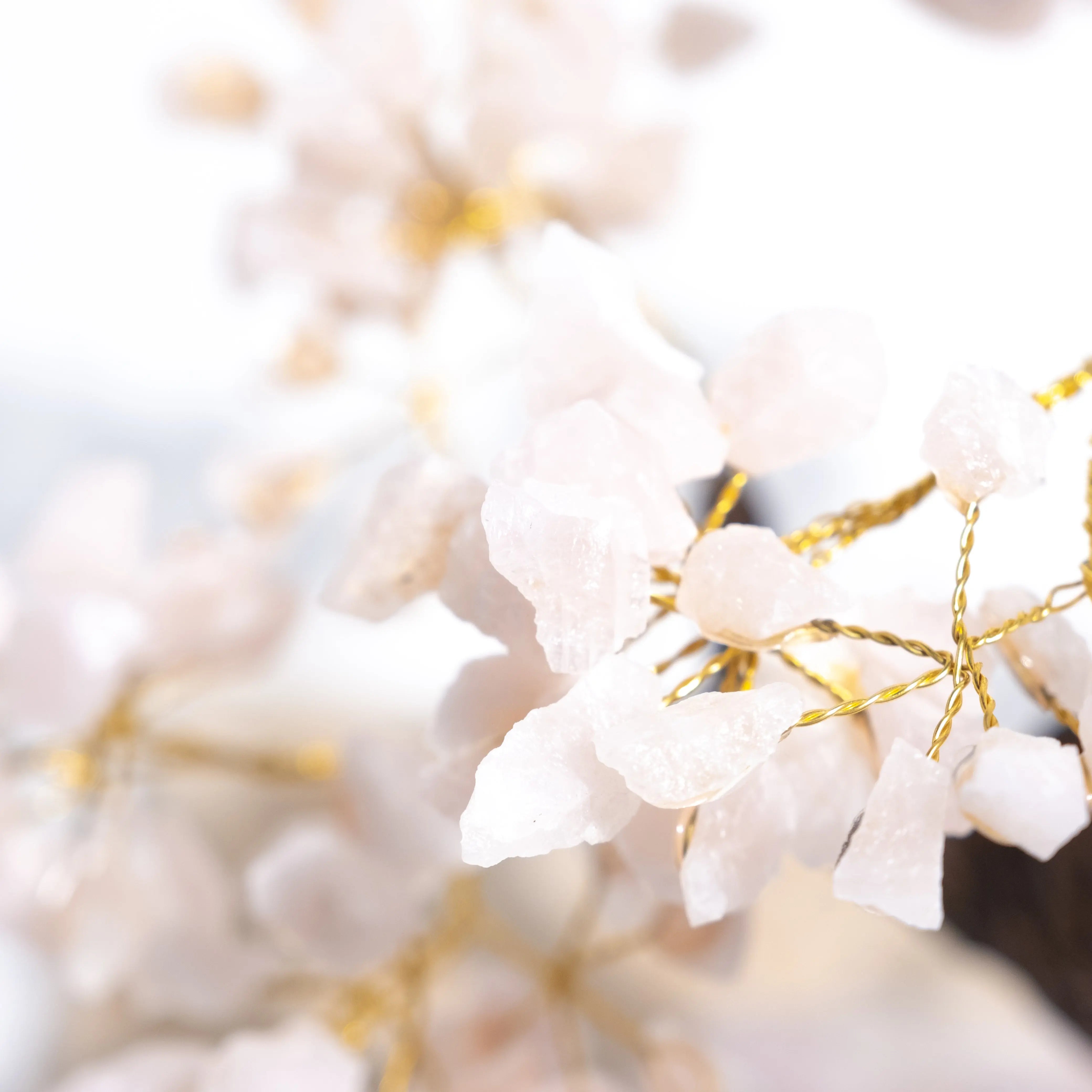Close-up of Rough Rose Quartz Tree branches with raw pink crystals, showcasing delicate energy and heart-opening properties.