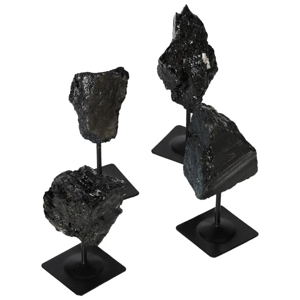 Rough Tourmaline on Metal Stand showcasing deep blacks and greens, elegant gemstone decor from Sylvia Crystals, symbol of luxury and harmony.