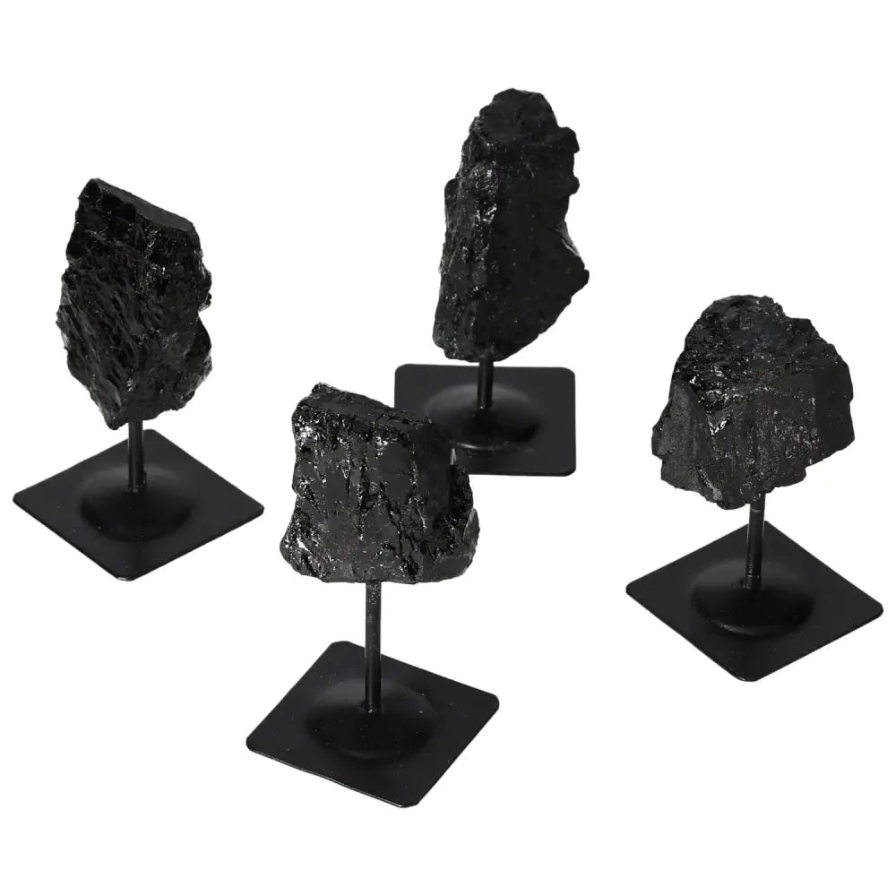Rough black tourmaline stones on metal stands, highlighting natural beauty and artistic design for home decor.