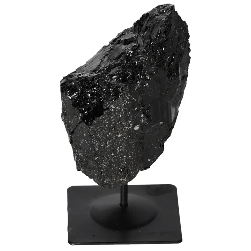 Rough tourmaline on metal stand, showcasing prismatic crystals; premium home decor by Sylvia Crystals. Enhance your space with elegance.