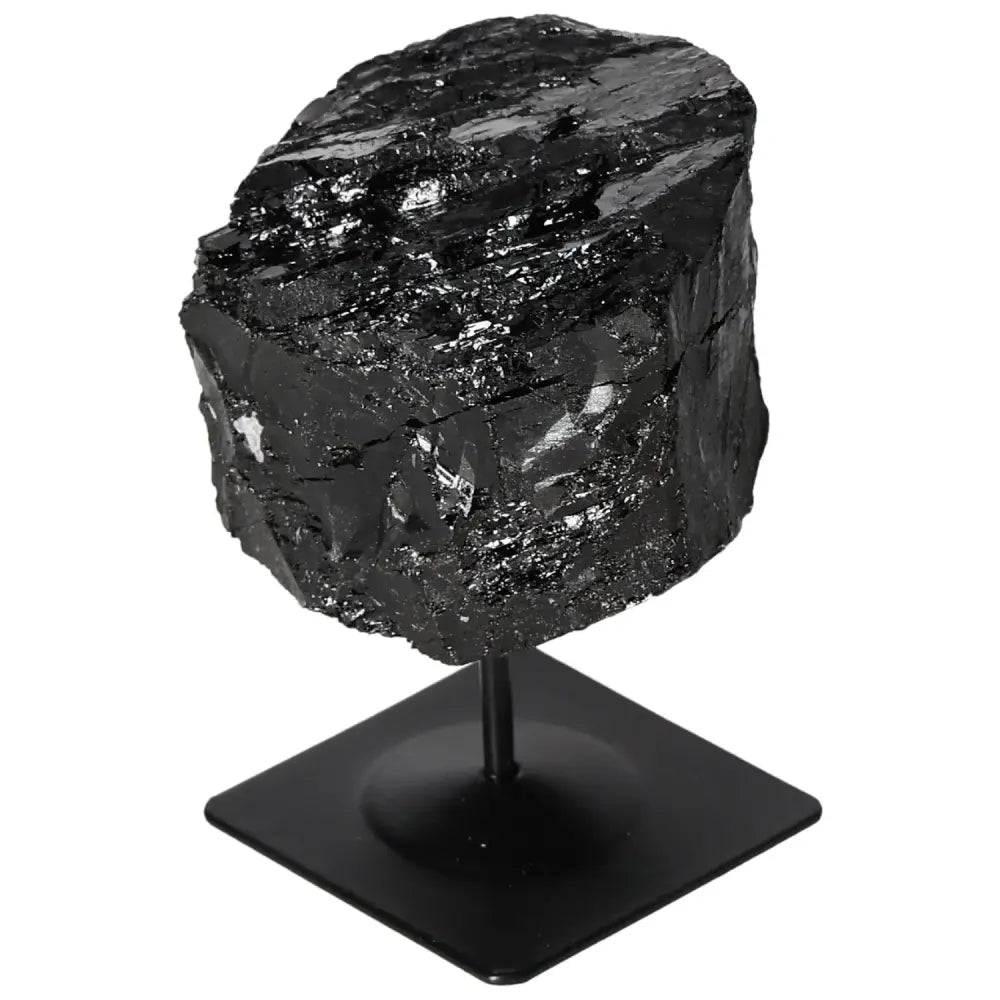 Rough black tourmaline crystal on a metal stand, showcasing natural beauty and vibrant hues from Sylvia Crystals collection.
