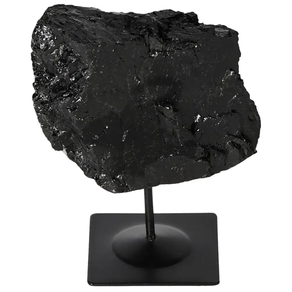 Black rough tourmaline on metal stand, showcasing its natural texture and energy-balancing properties as a decorative centerpiece.
