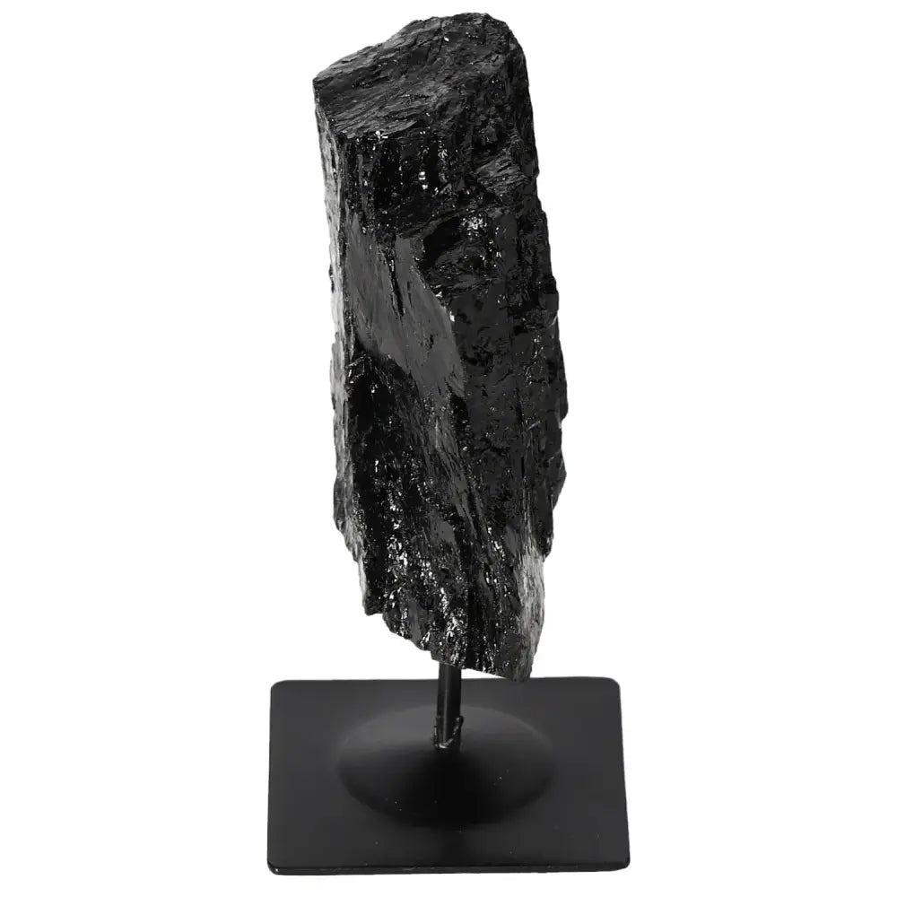 Rough black tourmaline crystal on a sleek metal stand, showcasing natural energy-balancing properties and ideal for home decor.
