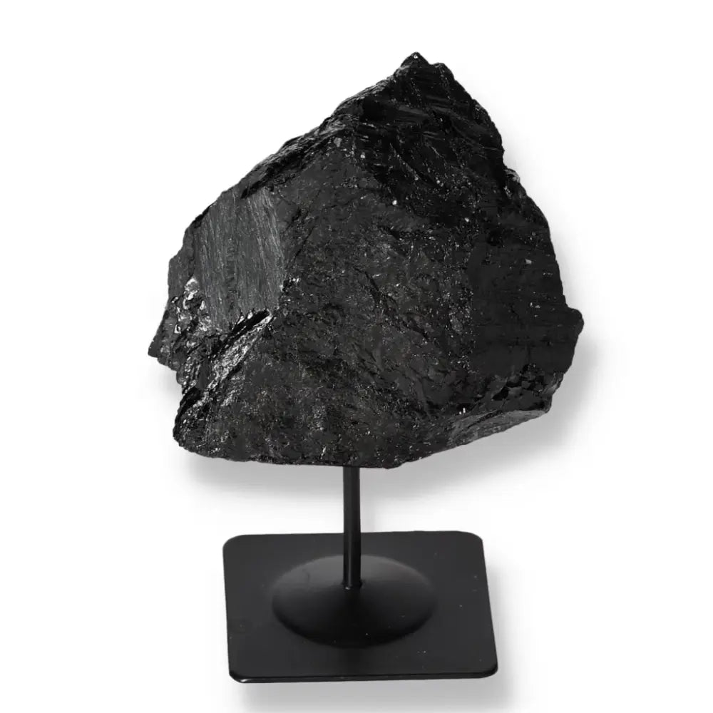 Rough tourmaline crystal on sleek metal stand, Sylvia Crystals premium gemstone home decor, blending natural beauty and modern design.