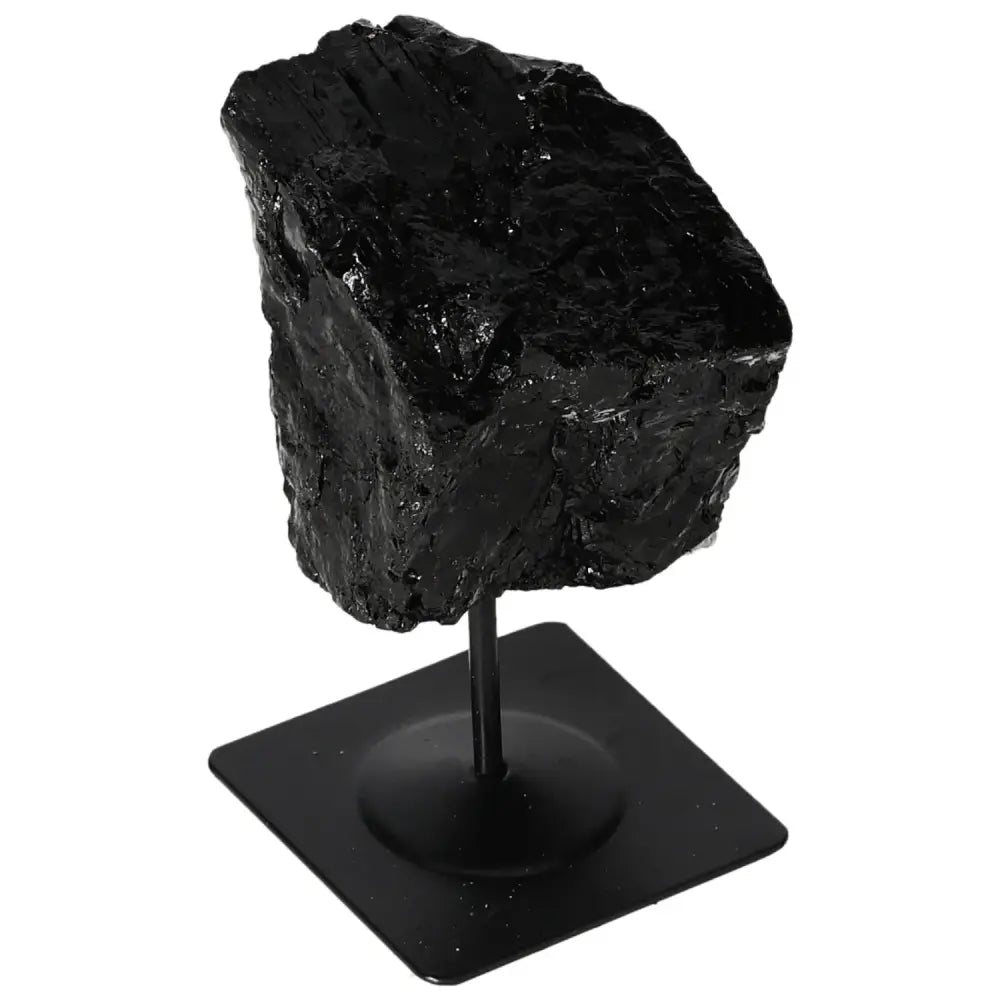 Rough black tourmaline crystal on metal stand from Sylvia Crystals, showcasing natural prismatic form and vibrant colors.
