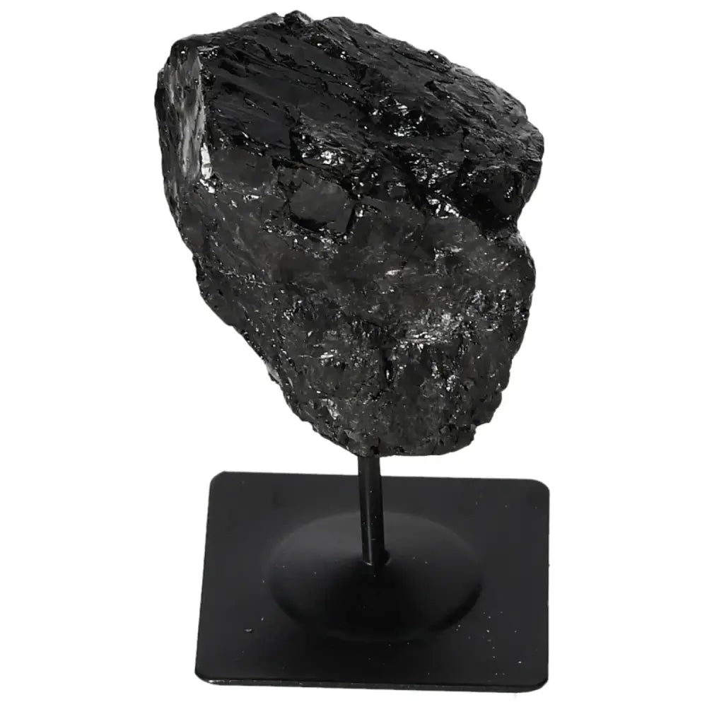 Rough black tourmaline on metal stand, showcasing raw beauty and vibrant colors. Premium Sylvia Crystals piece. Natural artistry decor.