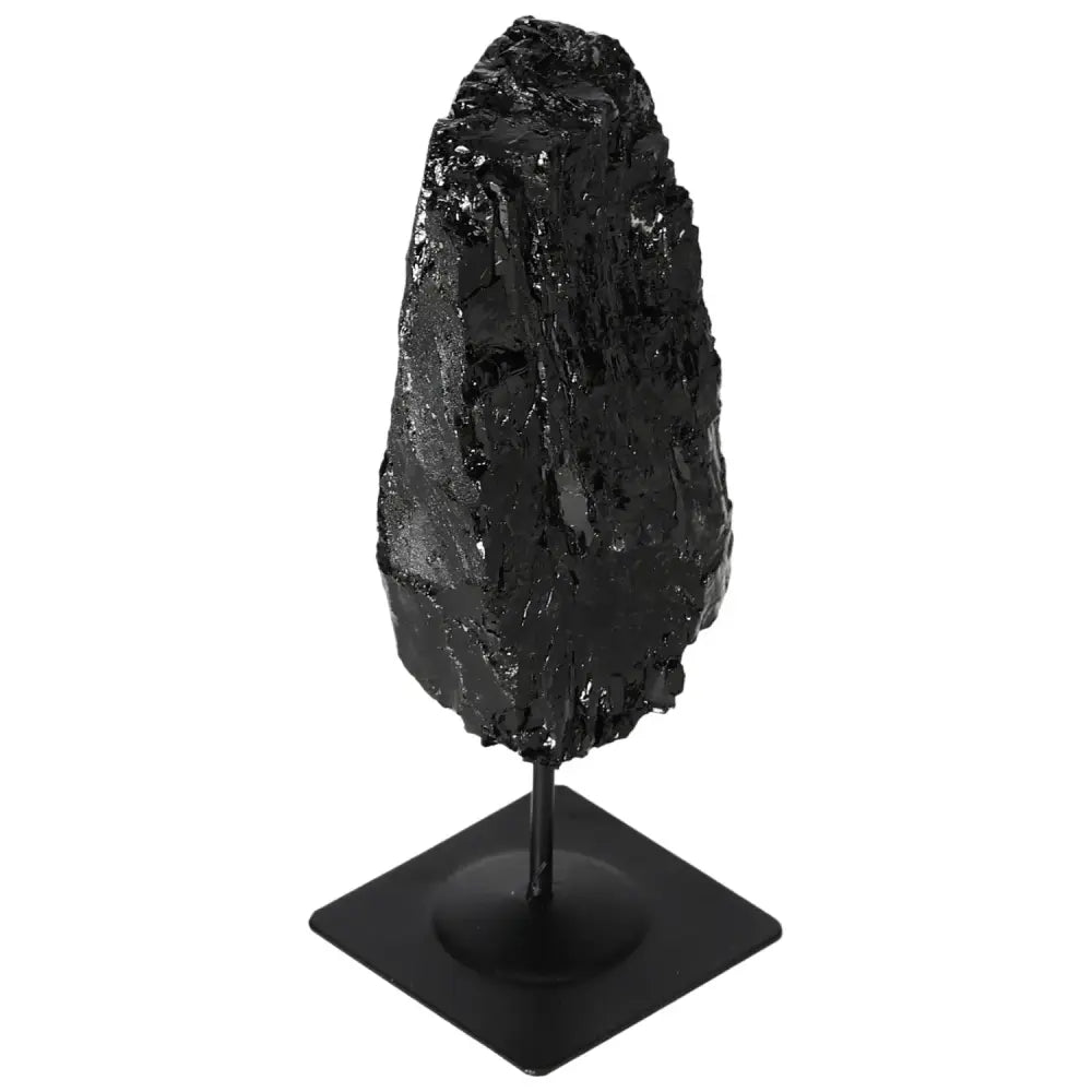 Rough tourmaline stone with metal stand, highlighting its natural beauty, offered by Sylvia Crystals.