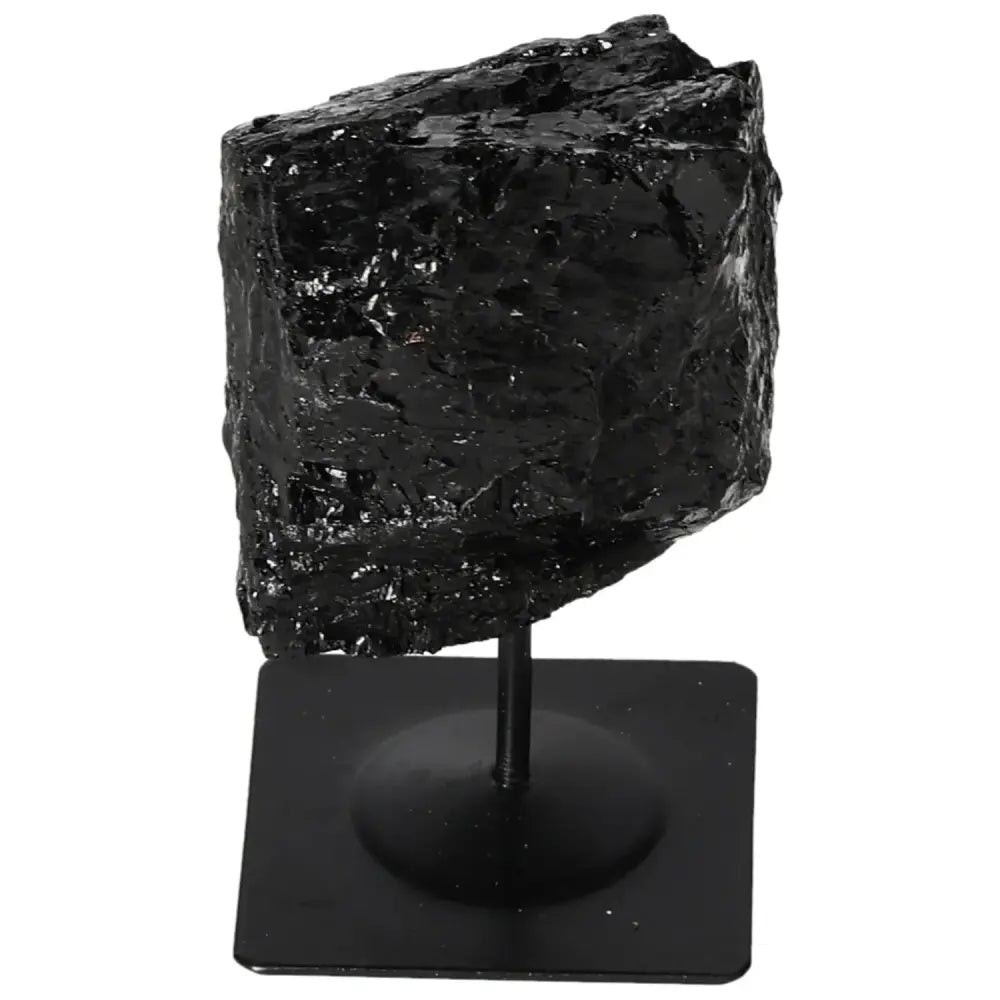 Rough black tourmaline crystal on metal stand from Sylvia Crystals, showcasing unrefined natural beauty and vibrant hues.