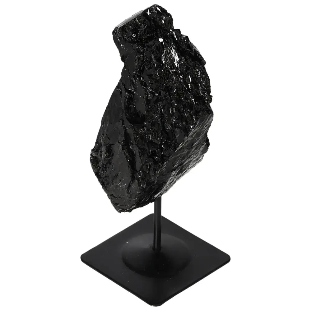 Rough black tourmaline crystal on a metal stand, elegant decor from Sylvia Crystals.