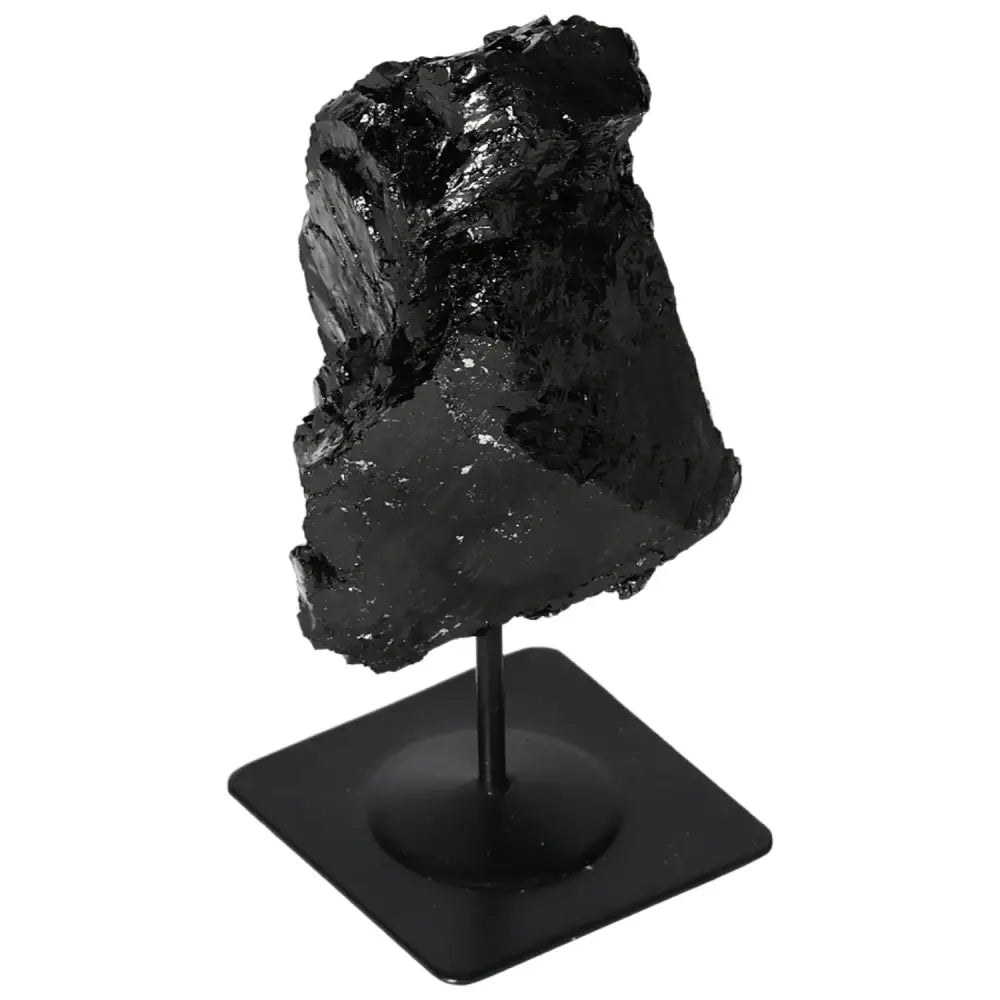 Rough tourmaline on metal stand, perfect for elegant home decor. Handpicked by Sylvia Crystals.