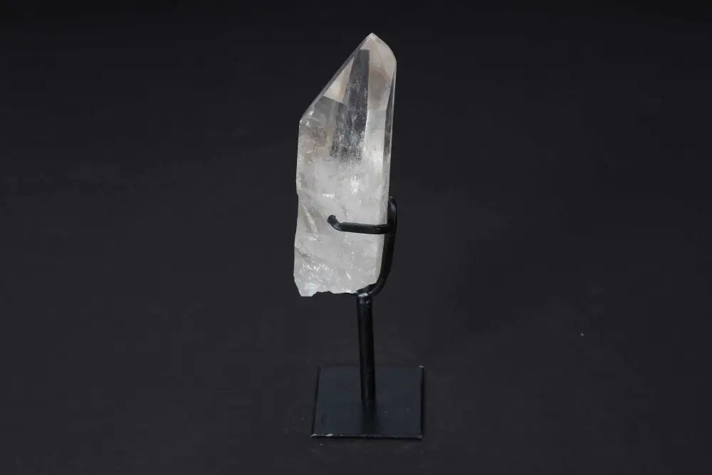 Semi Polished Clear Quartz Point on modern stand, ideal for meditation and energy work. Amplifies clarity and intention.