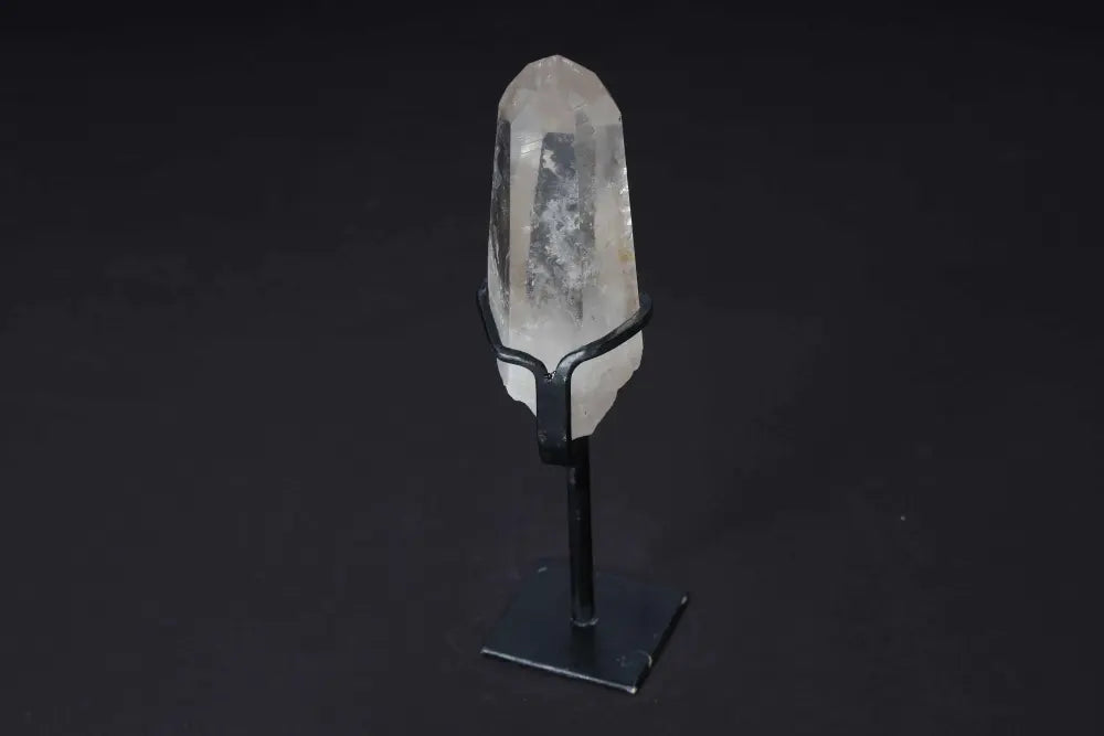 Semi Polished Clear Quartz Point with Stand, ideal for amplifying energy and clarity, elegantly displayed on a modern black stand.