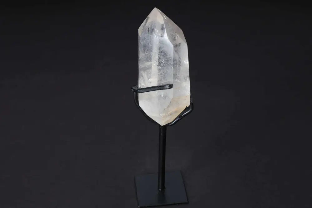 Semi-polished clear quartz point with modern stand, ideal for amplifying energy and clarity in meditation and manifestation practices.