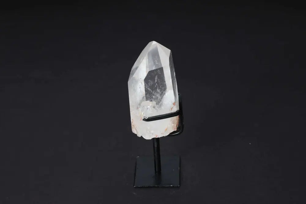 Semi polished clear quartz point on modern stand, ideal for energy work, meditation, and enhancing clarity in elegant spaces.
