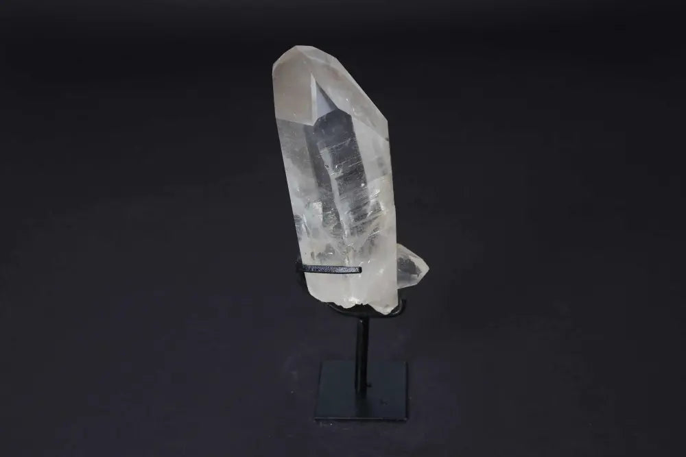 Semi polished clear quartz point with stand, ideal for meditation and energy work, amplifying and aligning focus in any space.