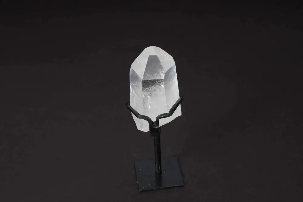 Semi-polished Clear Quartz Point on stand for amplifying energy and clarity, ideal for meditation and manifestation.