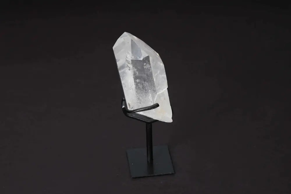 Semi polished clear quartz point on stand for energy amplification and clarity