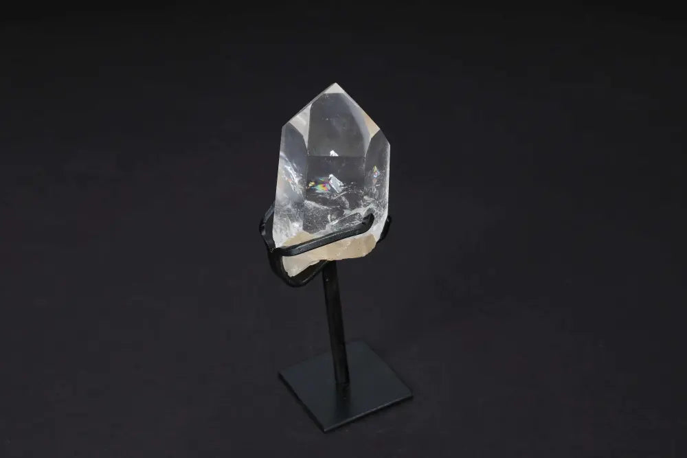 Semi Polished Clear Quartz Point on stand for energy amplification and clarity, ideal for meditation and manifestation practices.