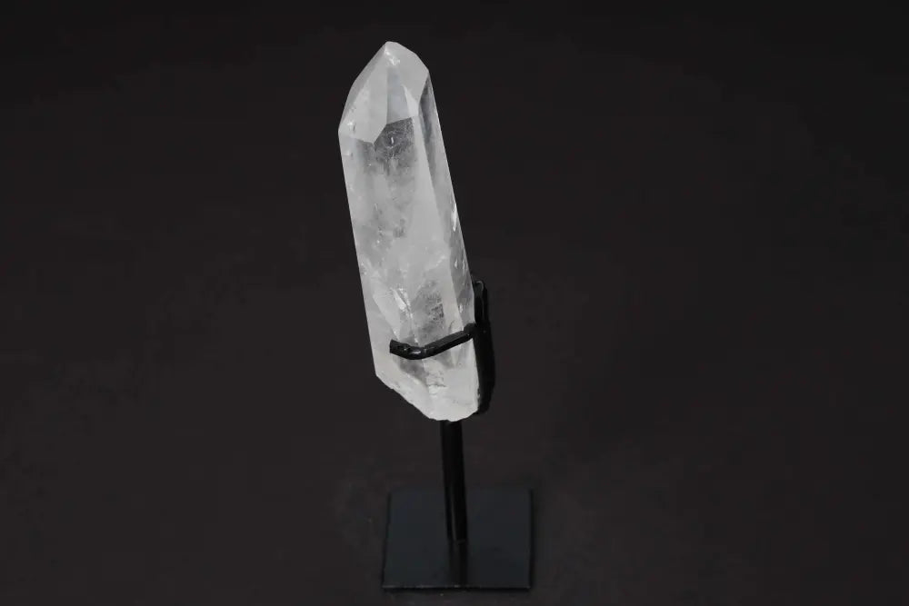 Semi-polished clear quartz point on stand, ideal for meditation, energy work, and enhancing clarity and focus in any space.