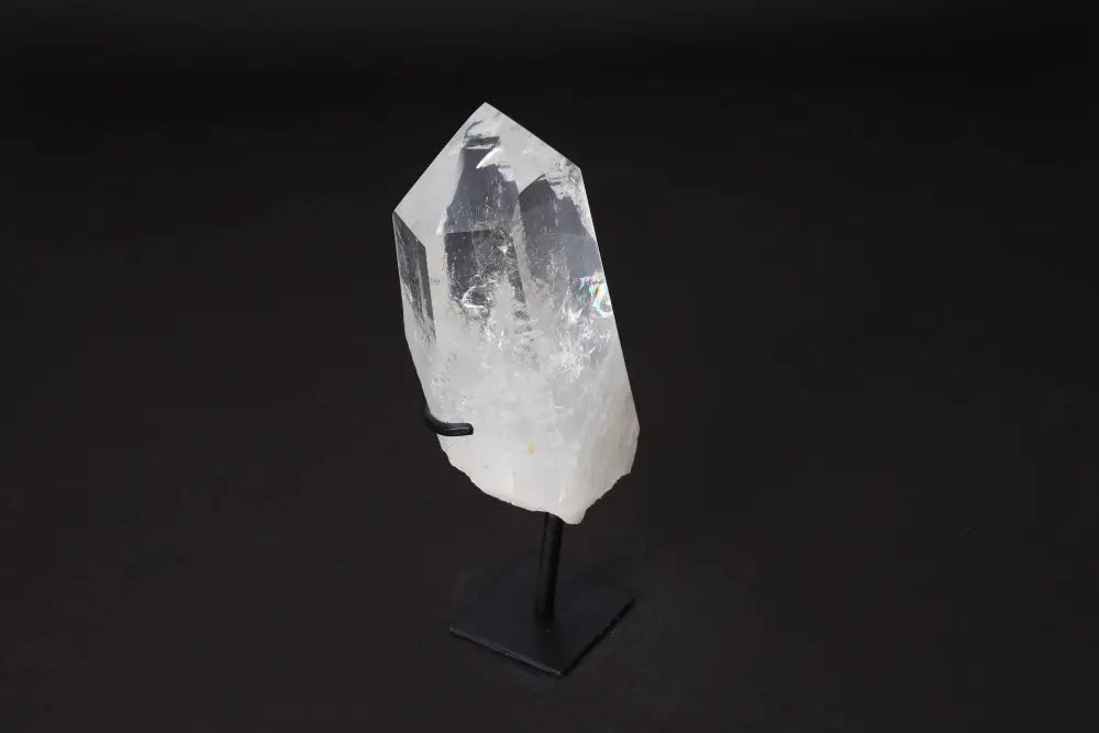 Semi polished clear quartz point on a modern stand, ideal for amplifying energy and enhancing meditation and clarity.