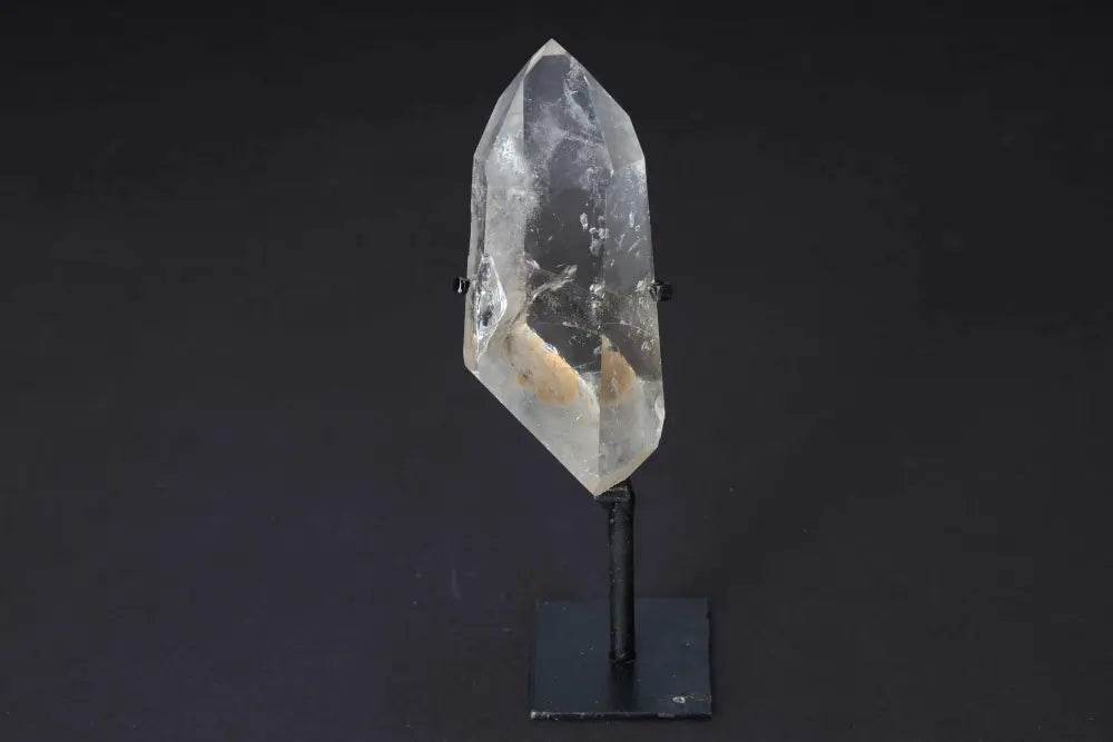 Semi-polished smoky quartz point with stand, showcasing earthy tones and smooth faces, ideal for grounding and protection.