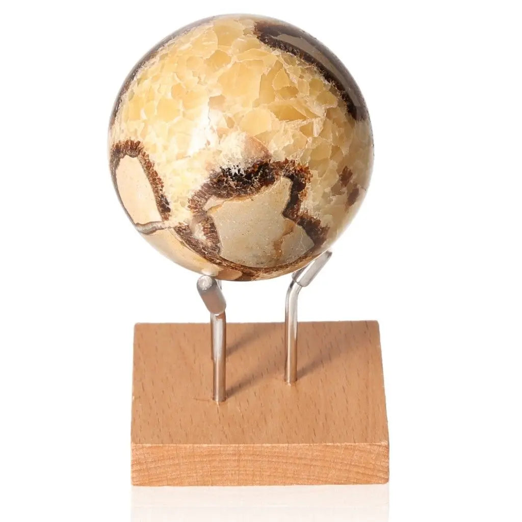 Polished Septarian Sphere on wooden stand, showcasing unique patterns and colors, symbolizing power and endurance.