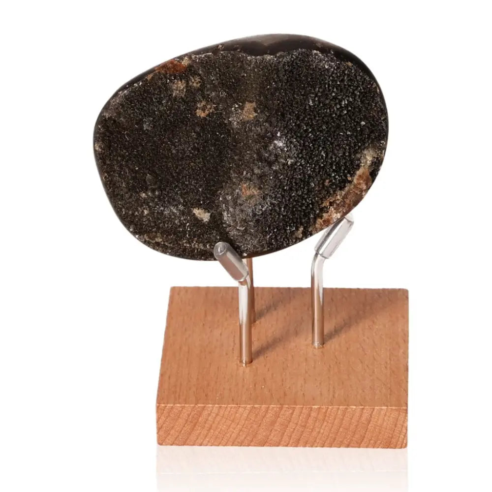 Septarian stone on display stand, known as Dragon Stone, symbolic of power and endurance, showcasing unique mineral patterns.