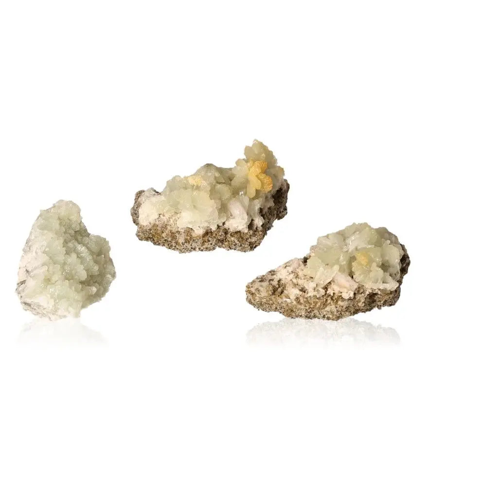 Small prehnite druzes with pale green and yellowish hues promoting inner peace and spiritual growth.