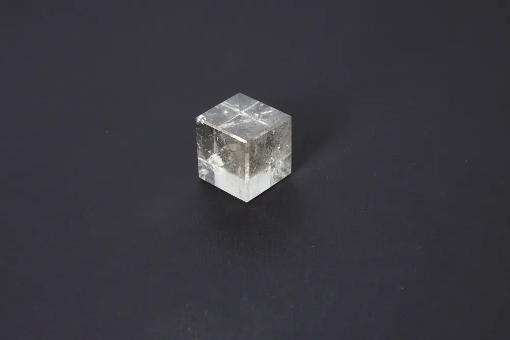 Smoky Quartz Cube 4cm on dark background, showcasing translucent gray and brown tones for grounding energy and emotional calm.