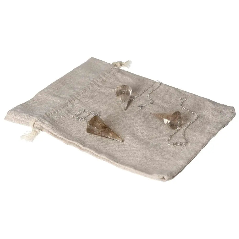 Smoky Quartz Pendulum on a fabric pouch, enhancing decision-making and grounding energy, ideal for business and clarity of thought.