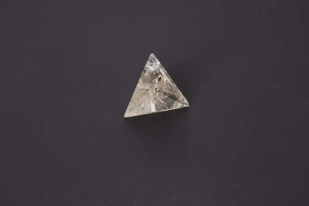 Smoky Quartz Pyramid 5 cm on dark background showcasing its grounding energy and rich translucent tones for emotional calm.