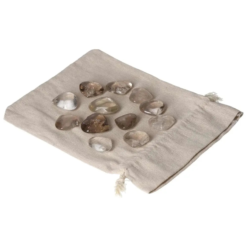 Collection of small smoky quartz heart stones on a beige pouch for business decision support and stress relief