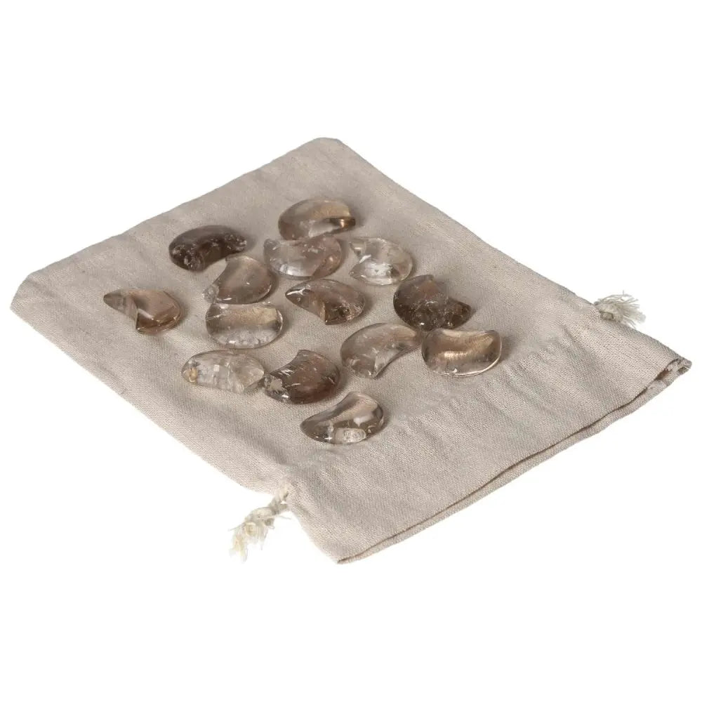 Smoky Quartz Small Moon gemstones on a beige pouch, promoting clarity and grounding for decision-making and stress release.