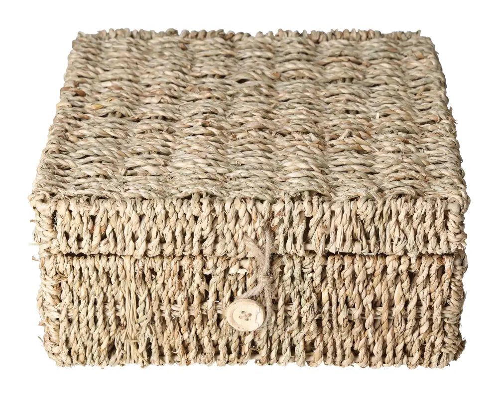 Handwoven natural wicker storage box with a button clasp, perfect for organizing small items elegantly and sustainably.