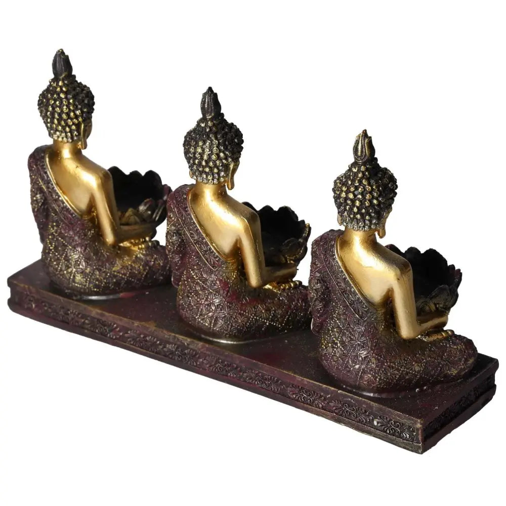Elegant triple Buddha tealight holder in decorative gold and maroon finish, symbolizing serenity and luxury for your home decor.