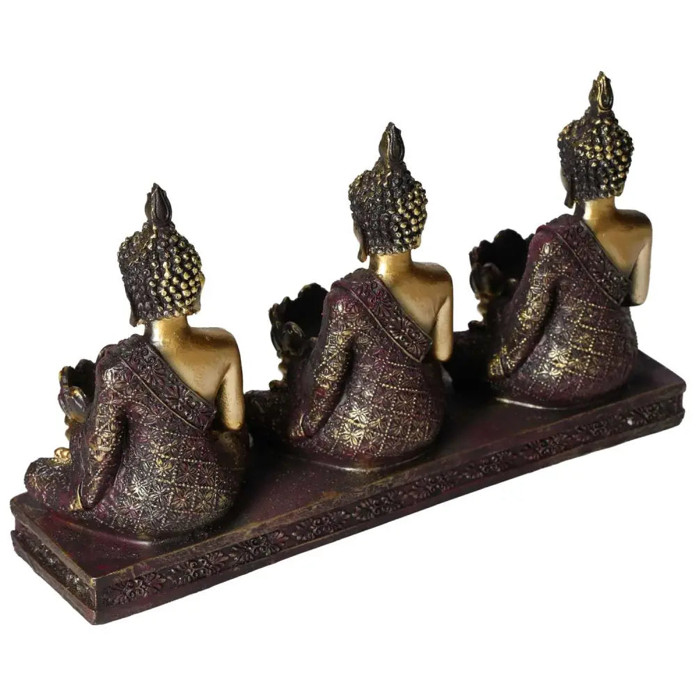 Three intricately designed Buddha tealight holders with luxurious finish, showcasing divine geometry on a decorative base.