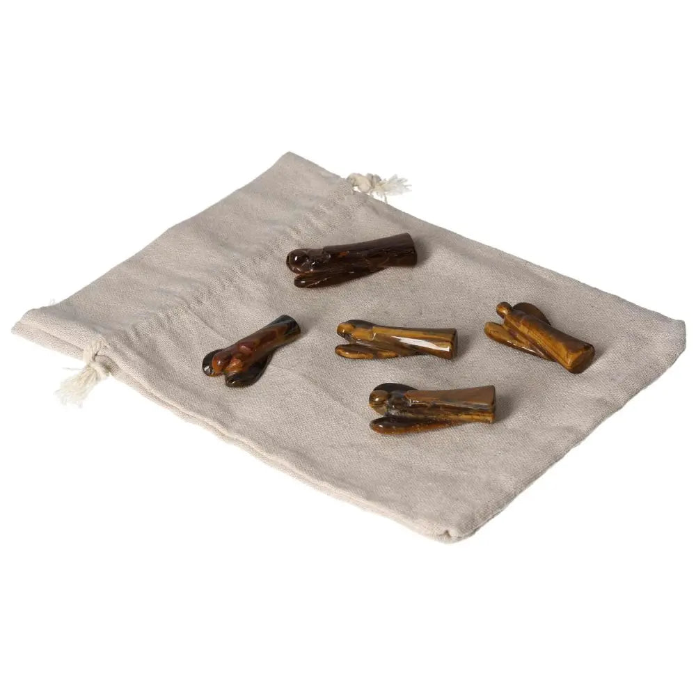 Small Tiger's Eye angels on a beige pouch, symbolizing protection, strength, and spiritual guidance with golden-brown shimmer.