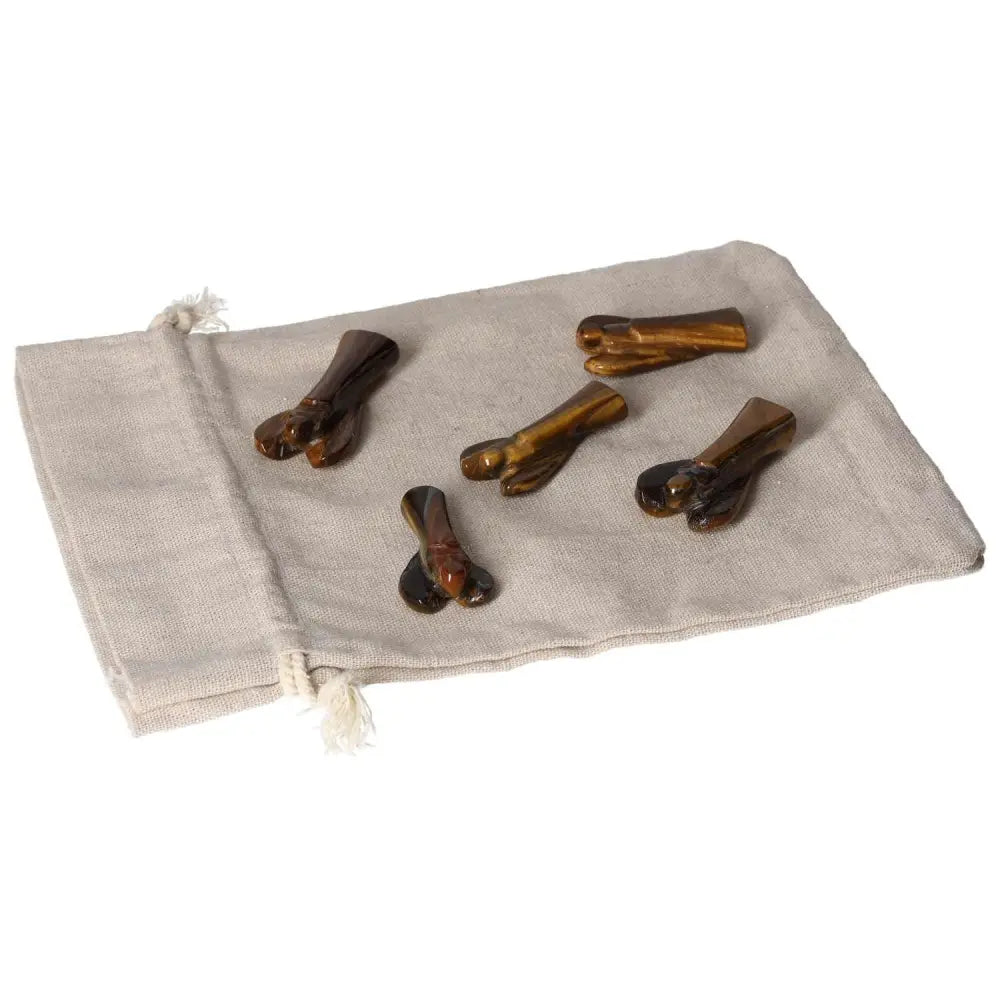 Small Tiger's Eye angels on a beige cloth, symbolizing protection, strength, and divine guidance with a golden-brown shimmer.