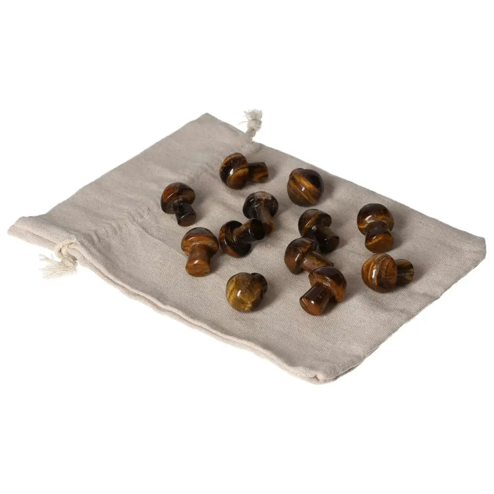 Tiger's Eye small mushroom stones on a fabric pouch, enhancing mental clarity, stability, and joy while aiding in wealth management.