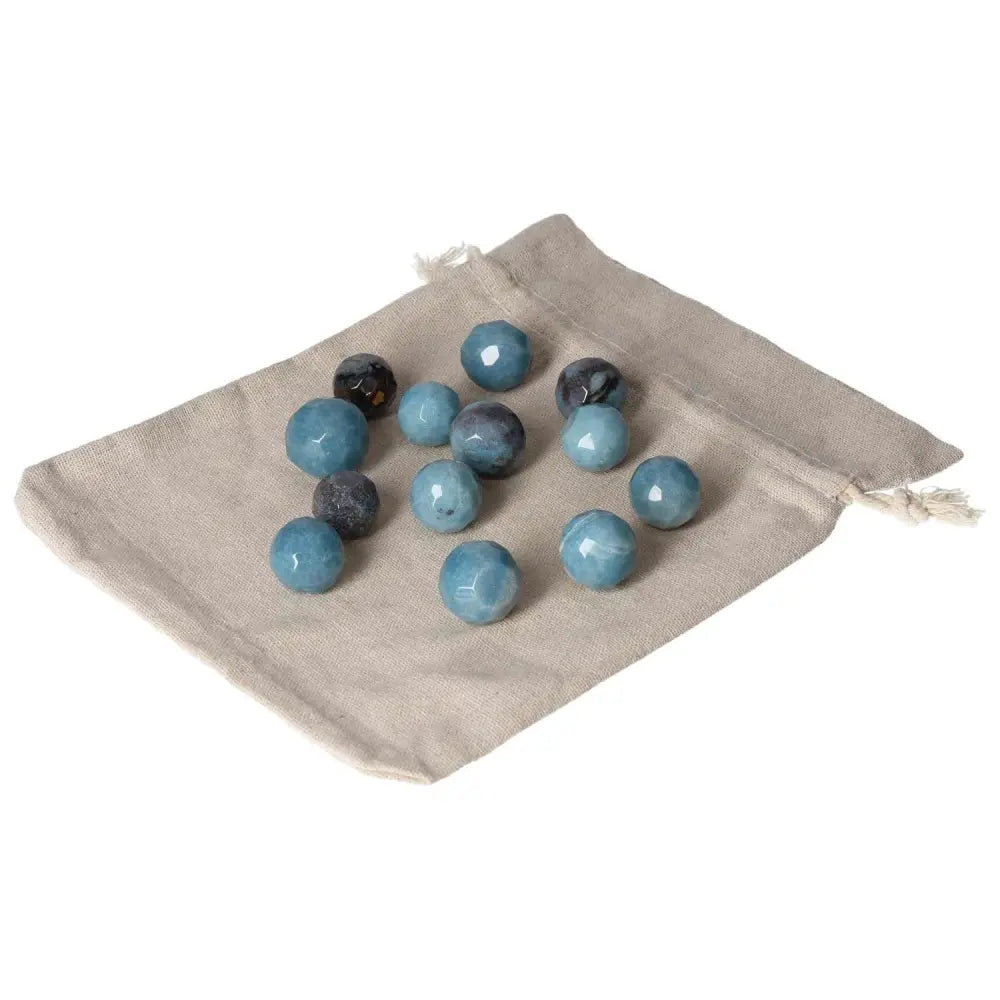 Assorted blue Trolleite small geometric spheres on a beige pouch symbolizing intuition and spiritual awareness.
