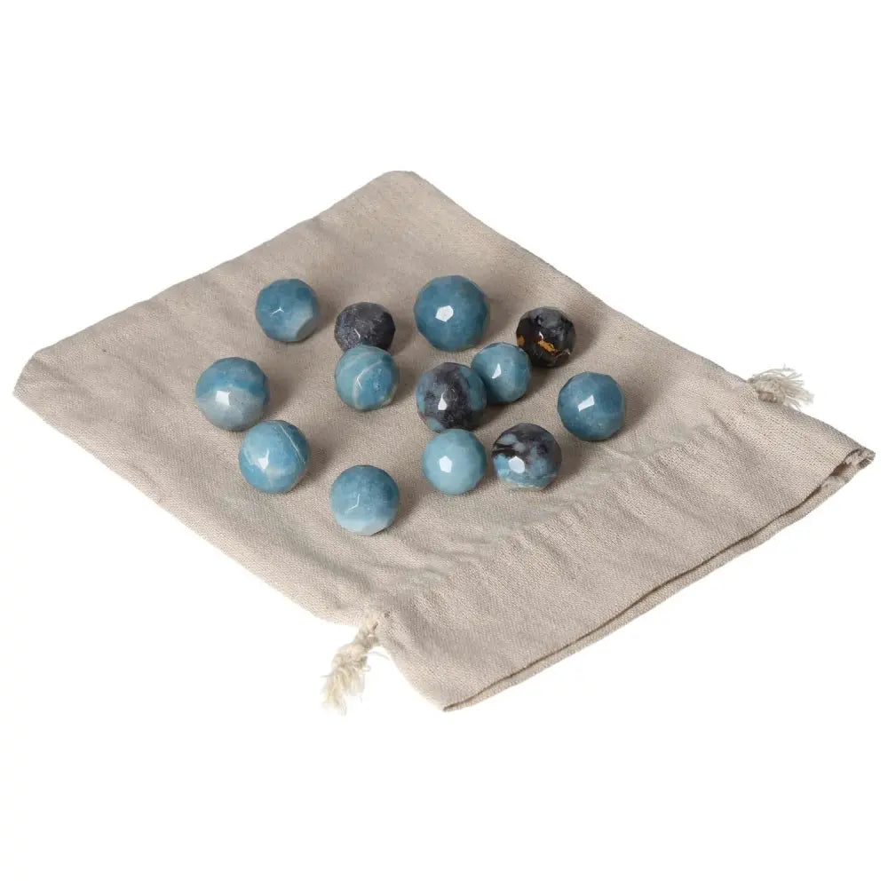 Trolleite small geometric spheres on a fabric bag, showcasing rich blue and violet colors, symbolizing intuition and spiritual awareness.