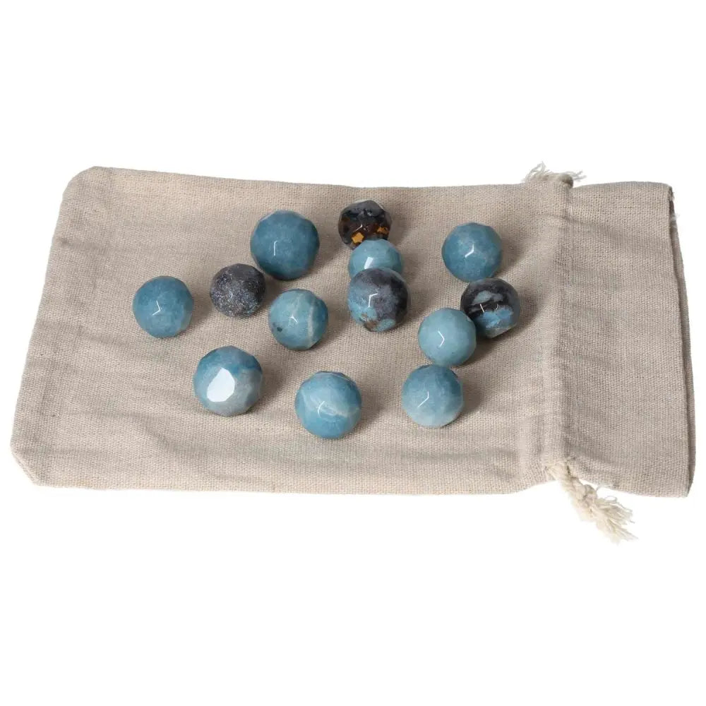 Trolleite small geometric spheres with rich blue colors on a beige fabric, symbolizing spirituality and intuition.