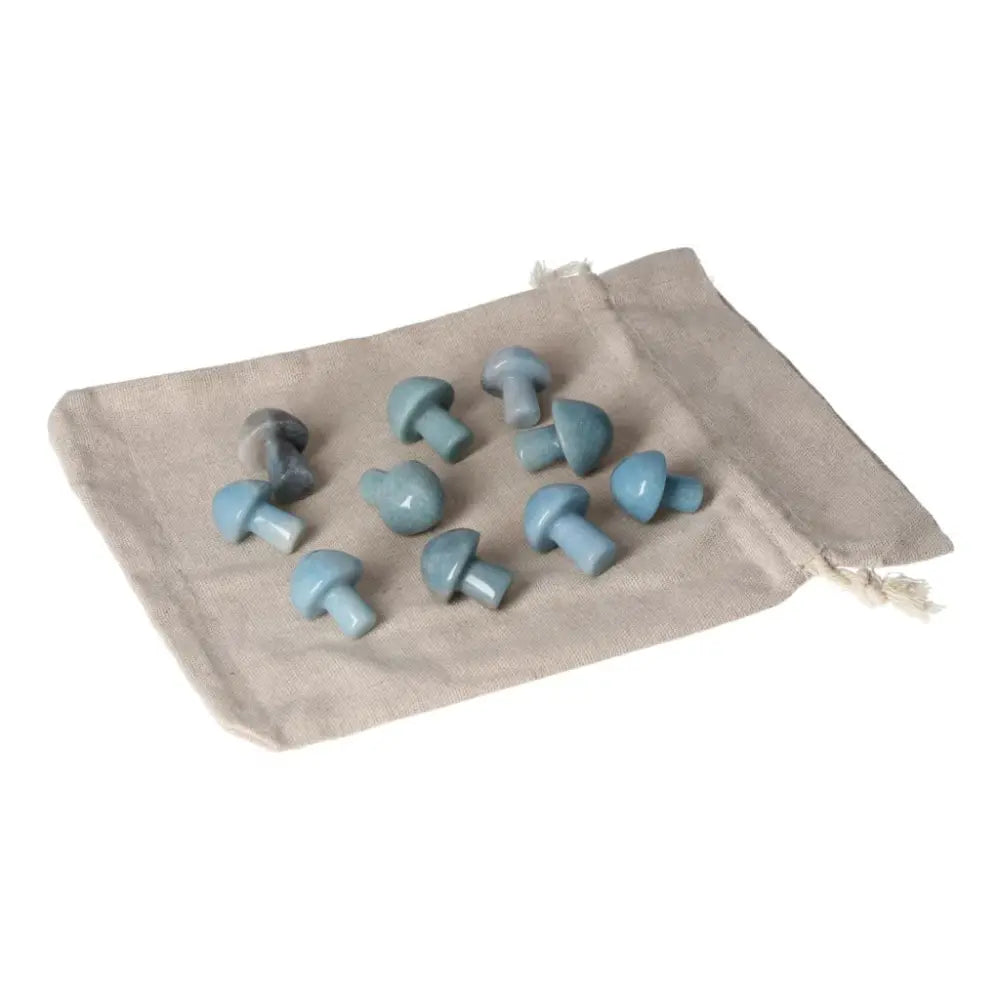 Small trolleite mushroom stones in blue and violet tones, symbolizing intuition and spiritual growth, on a beige cloth bag