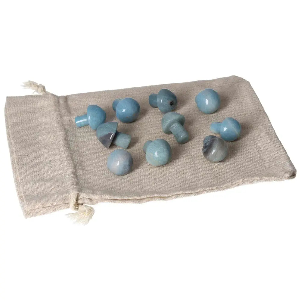 Trolleite small mushroom stones on a beige pouch, showcasing their blue to violet hues for spiritual awareness and intuitive potential.